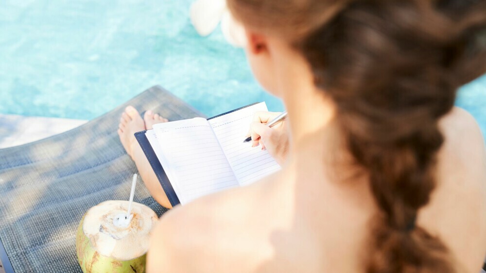 Woman journaling at the pool