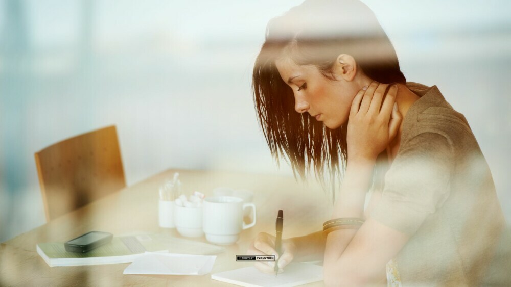 Woman journaling behind desk