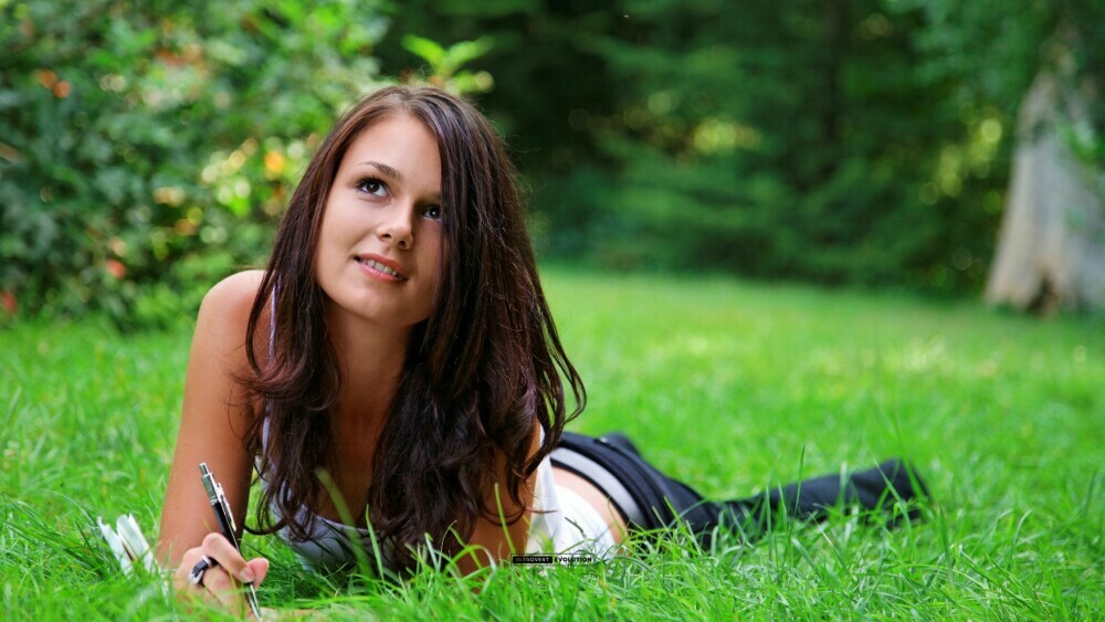 Woman journaling on the grass